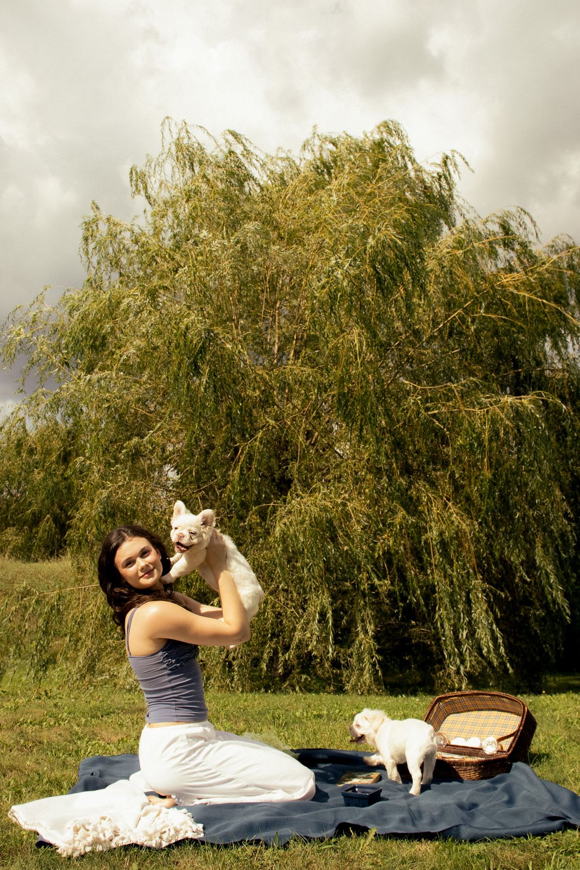 Holding up a MonRoyal Frenchies puppy at a picnic